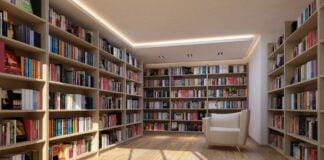 What Editorial Curation Means for AI Search Visibility Modern home library with floor-to-ceiling bookshelves and white armchair exemplifies the organized curation and structured knowledge systems that enhance search discoverability.