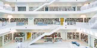 How an online MBA in human resources management can reshape your career A multi-story modern library with organized bookshelves on multiple levels connected by white staircases, illustrating hierarchical structure and systematic organization for site navigation.