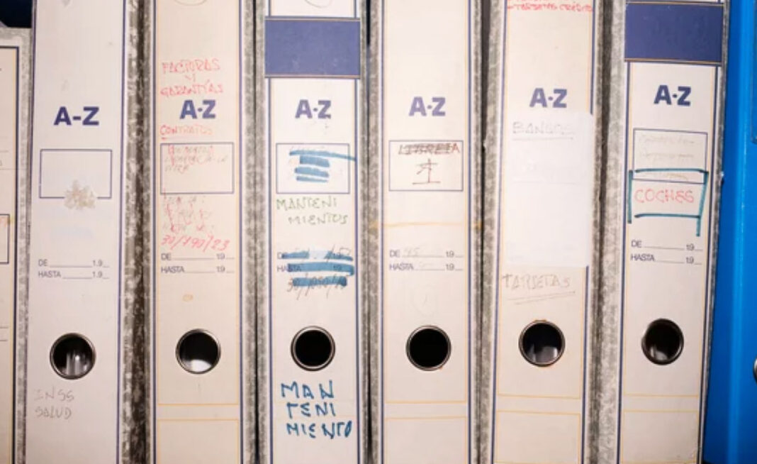 Organized file storage system illustrating data dignity and responsible information management practices White ring binders labeled A-Z arranged on a shelf with handwritten dates, representing systematic organization and responsible data management for user privacy protection.