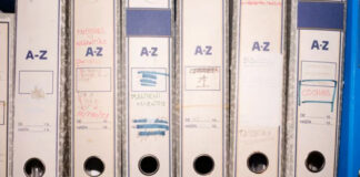How Medical Device Regulations Apply to Spinal Implants White ring binders labeled A-Z arranged on a shelf with handwritten dates, representing systematic organization and responsible data management for user privacy protection.