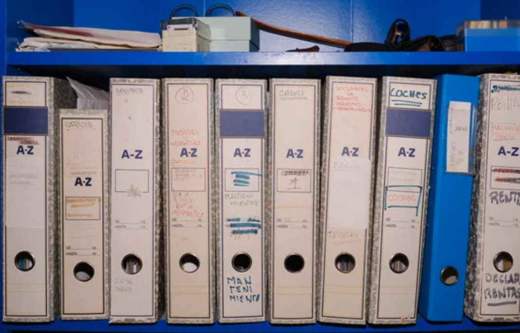 archival-binders-filing-system-z-labels-blue-shelf-organization White archival binders with handwritten A-Z labels line a blue shelf, demonstrating the systematic organization principles that distinguish curated directories.