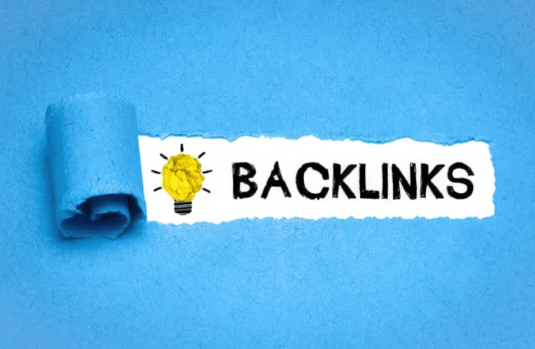 Creative backlinks strategy illustration for making business listings more discoverable online Torn blue paper reveals the word BACKLINKS beside a hand-drawn lightbulb with crumpled yellow paper inside, illustrating link-building strategies for standout business listings.