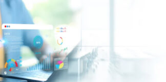 Charging Per Lead: The Performance-Based Monetization Model for Service Niches Business professional's hands on laptop with colorful translucent charts and graphs overlay, representing performance-based monetization tracking and lead generation metrics.