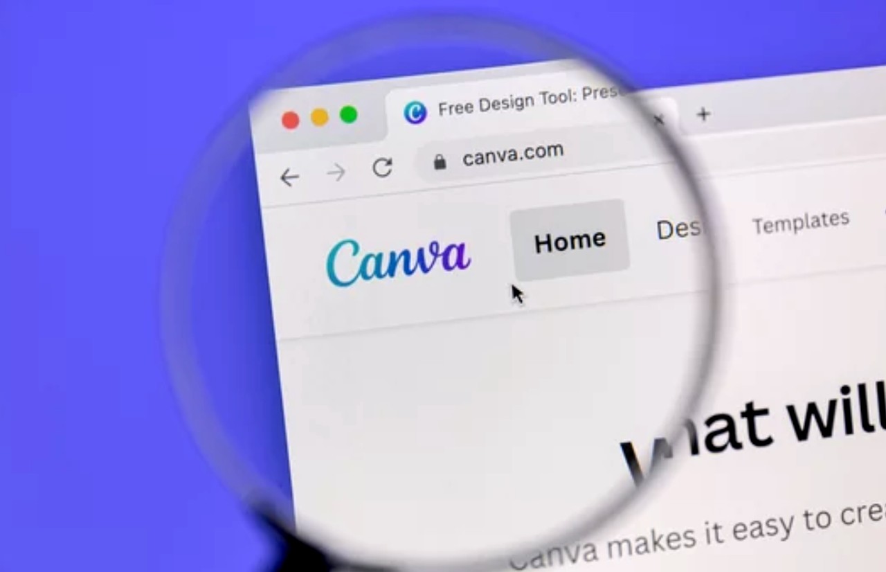 Magnified view of Canva website homepage showing logo and navigation in a browser window, representing digital design tools for ad creative development.