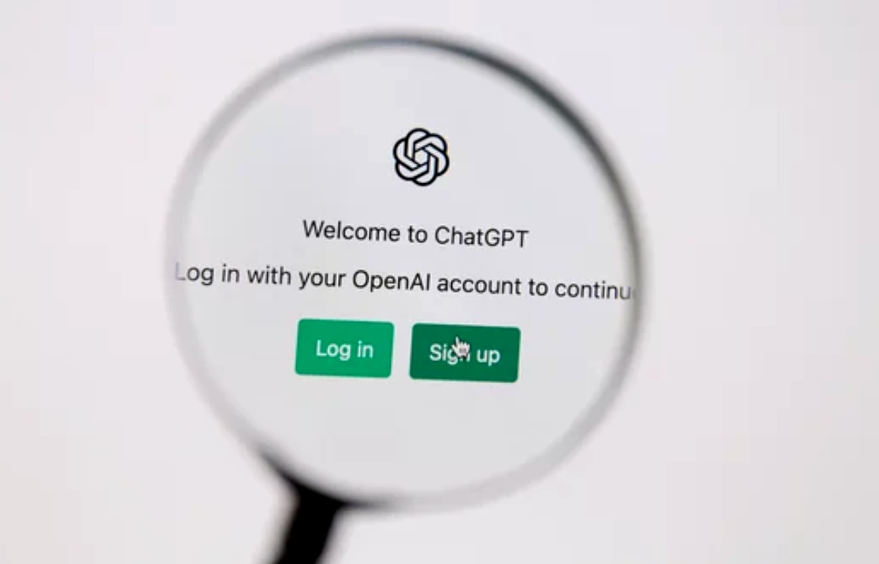 Magnifying glass enlarging a ChatGPT login screen with OpenAI logo and green buttons, representing the conversational marketing platform interface.
