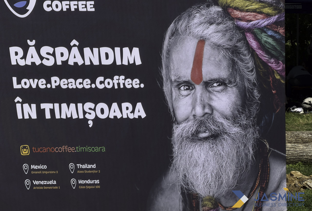 Outdoor banner advertisement for a coffee business featuring a monochrome portrait and location information, illustrating local advertising techniques for retail businesses.