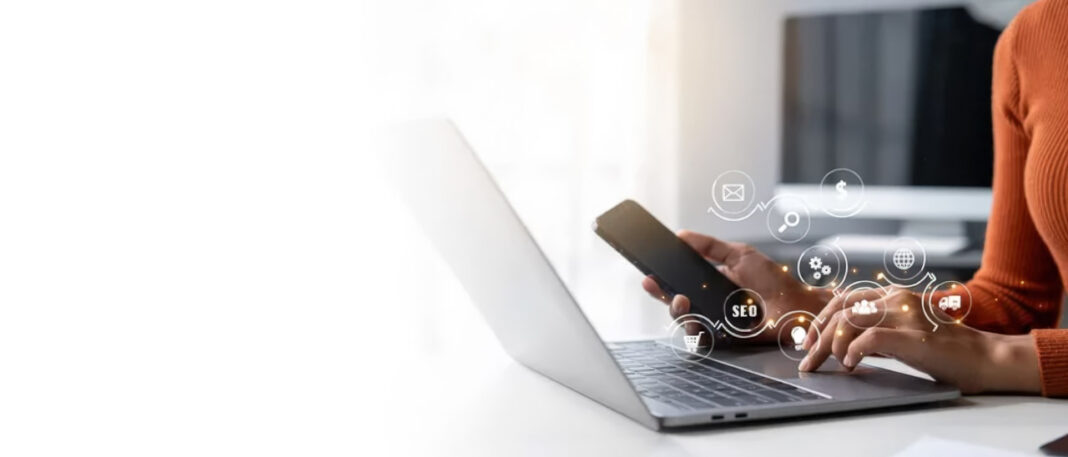 Multi-device workspace illustrates coordinated multichannel marketing strategy across digital platforms Person using laptop and smartphone at desk with digital marketing icons overlaid, representing coordinated multichannel marketing strategy across business platforms.