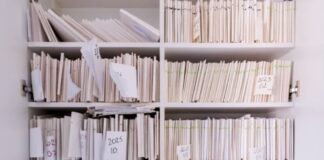Industry-Only US Directory Strategy Works Best White shelving unit filled with organized papers and labeled file compartments, representing the systematic categorization approach used in industry-specific business directories.