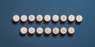 Wooden circular tokens arranged to spell 'duplicate content' on a blue surface, representing the challenge of maintaining consistent business information across online directories.