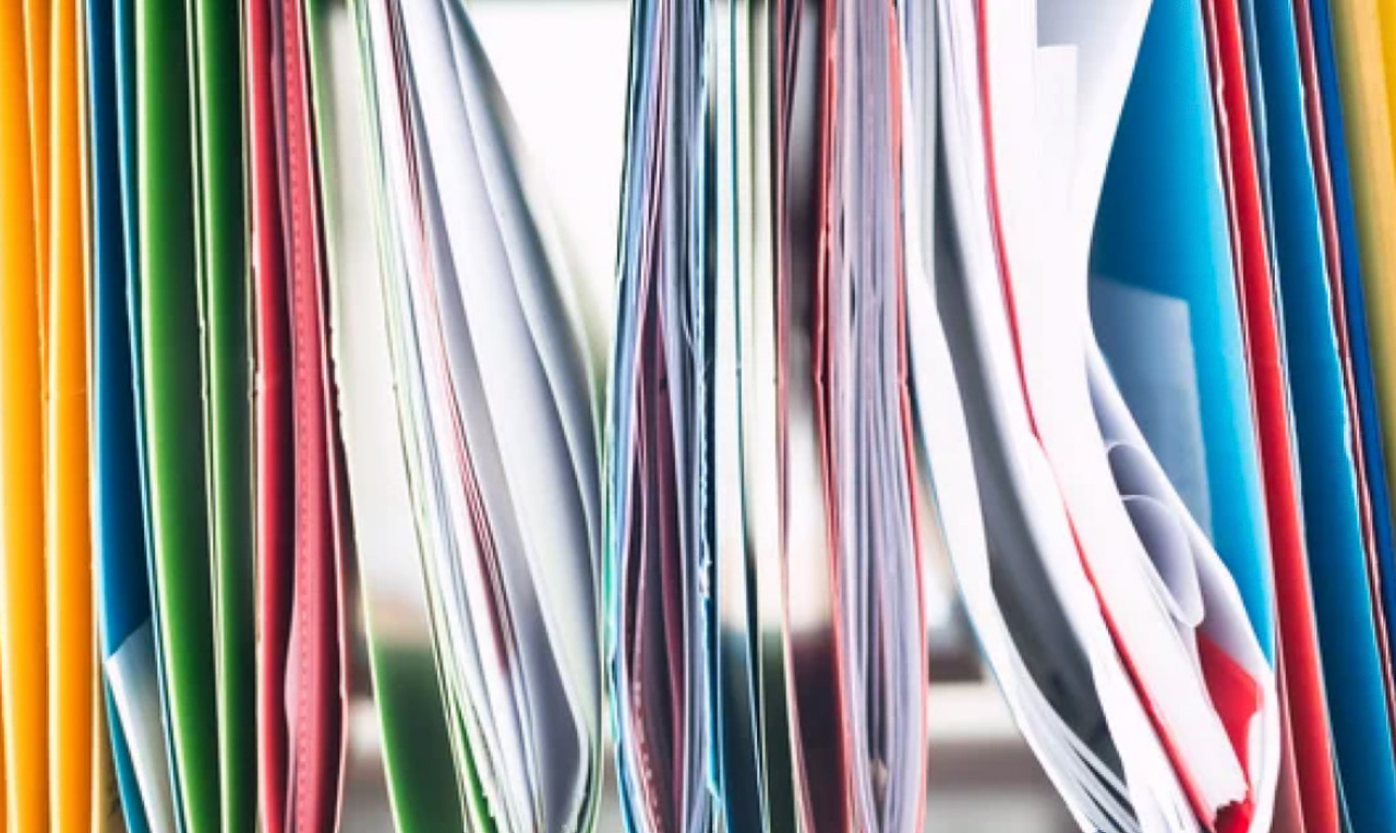 Fanned magazine pages display vibrant multicolored edges against white paper, representing the diversity and variety found in industry-specific directory categorization.