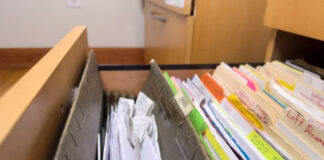 A Simple Guide to Business Directories Open filing drawer with organized documents, colored folders, and gray dividers demonstrating systematic organization methods applicable to business directory structures.