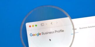 Google Business Profile vs Web Directories: AI Era Magnifying glass enlarging Google Business Profile webpage on computer screen, illustrating the importance of optimizing business visibility in digital directories and local search platforms.