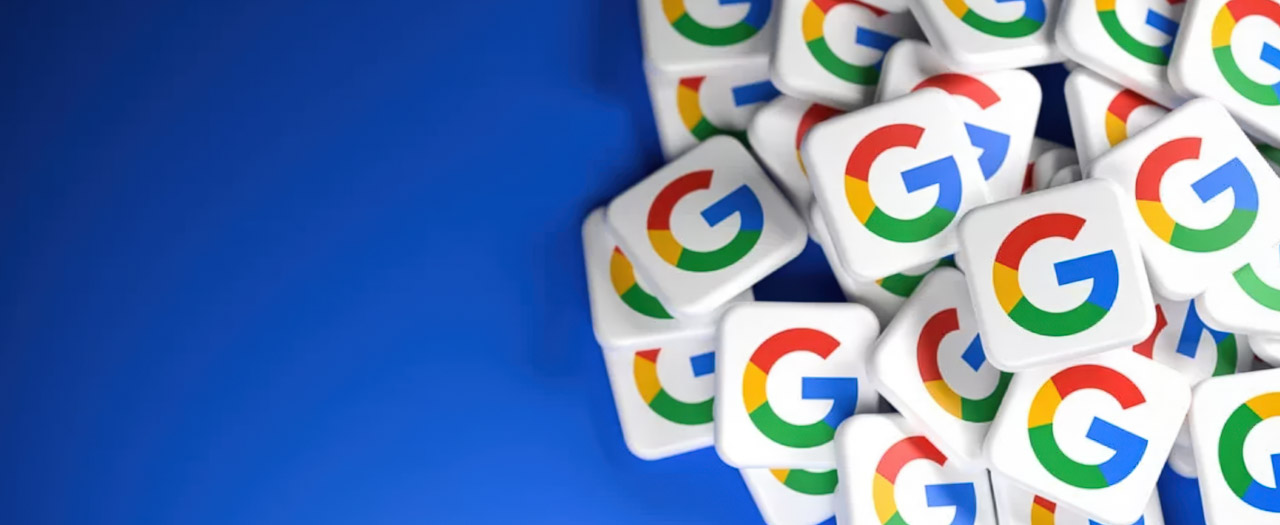 A pile of Google logo stickers on a blue background, symbolizing online business listing platforms and digital directory presence for improved visibility.