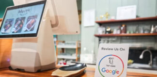 Stop Ignoring Your Local Customers Google review stand with NFC tap symbol and five stars sits on a restaurant counter, illustrating how local businesses engage customers for feedback.