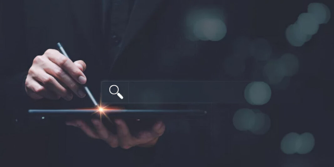 Digital tablet and stylus illustrate visual search technology for camera-driven consumer discovery Hand holding stylus over tablet showing search icon with glowing interface, representing visual search and camera-driven discovery technologies in modern retail.