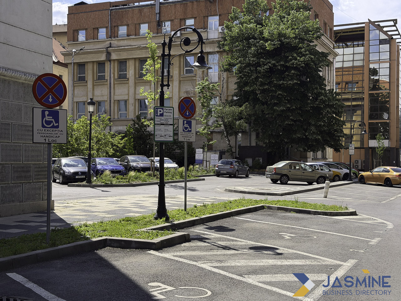 Marked handicap parking spaces in an urban parking lot in Timișoara, illustrating the visibility of accessibility attributes that help customers find suitable business locations.