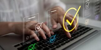 Can I edit my listing once it’s live? Hands typing on laptop keyboard with digital checkmark and document icons overlaid, illustrating the process of editing online business directory listings.