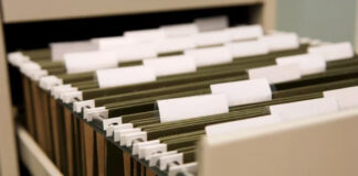 Are there any new directories? Hanging file folders with white tabs organized in a storage drawer, illustrating traditional information organization methods in contrast to modern digital directories.