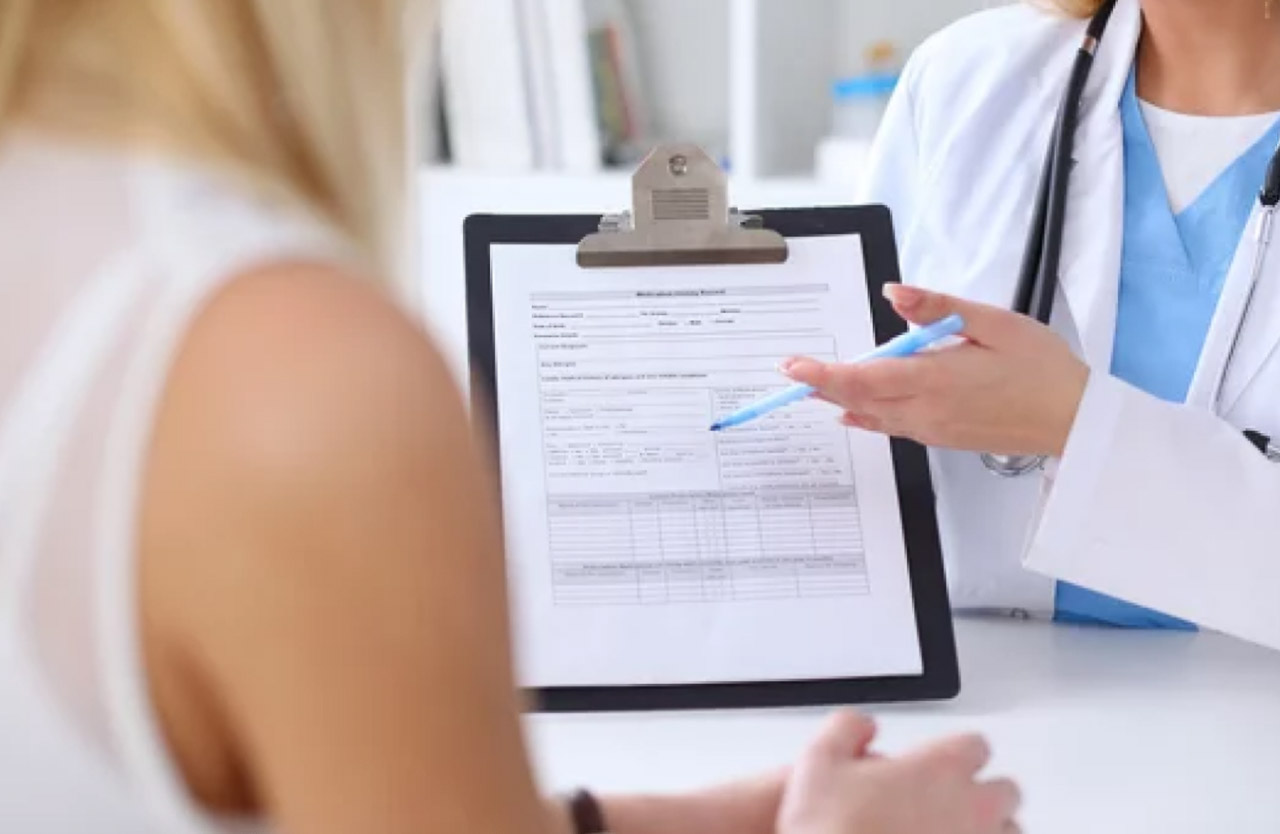 A doctor in white coat holding a clipboard with medical documentation presents it to a patient, representing the shift toward credentialed expert authority.