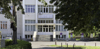 Airflow and Temperature Control in Large Warehouse Spaces Multi-story Hidrotehnica institutional building with concrete stairs and glass entrance in Timișoara, representing the professional organizations that engage with academic and institutional directories.