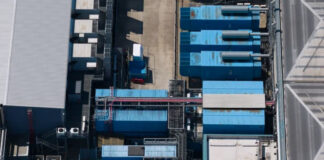 Asian Megacity Directories Drive Major Sales Aerial view of industrial facility with blue corrugated rooftops and ventilation equipment, representing the commercial infrastructure that supports business directories in metropolitan markets.