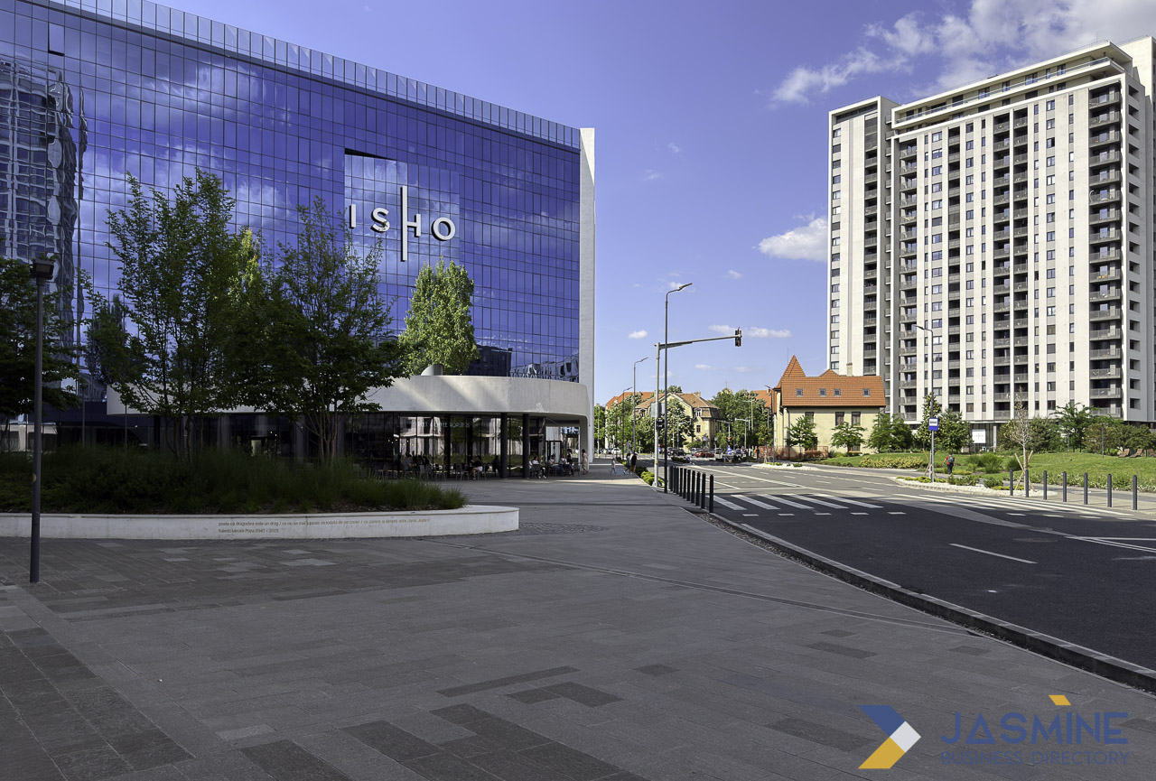 Modern glass office building with ISIO signage on an urban plaza in Timișoara, illustrating corporate visibility for local business advertising.