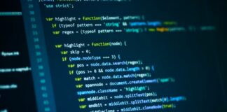 The “DOM” vs. The Source Code: What Google Actually Sees Computer monitor displays JavaScript code with syntax highlighting showing DOM manipulation functions, illustrating the technical difference between source code and rendered web pages.