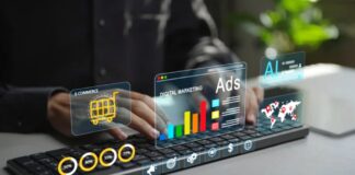 Advertising on “The Edge”: Reaching Users on IoT Devices Hands typing on a laptop with translucent digital marketing graphics and data charts floating above, representing advertising technology reaching connected IoT devices.
