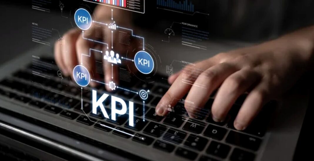 Digital analytics interface demonstrates tools essential for AI-powered SEO workflows Hands typing on a laptop keyboard with a holographic overlay showing KPI metrics and data visualizations, illustrating modern AI-powered SEO analysis tools.