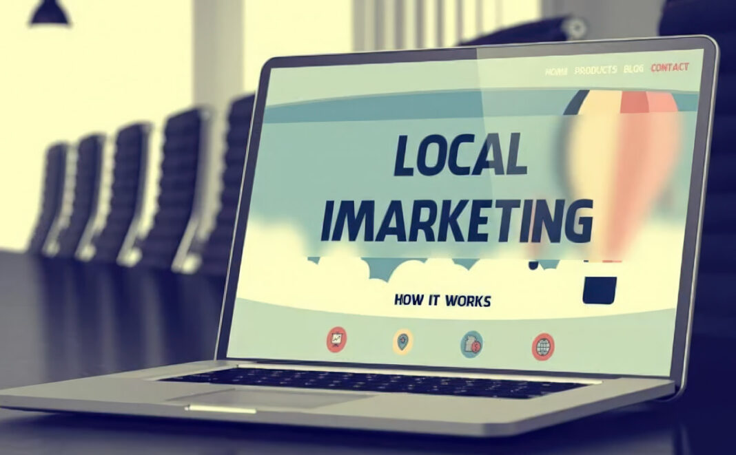 Digital marketing tools illustrate how business directories drive organic growth and customer discovery Laptop displaying a local marketing website on an office desk, representing digital tools that help businesses increase their discoverability and organic reach.