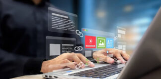 Hands typing on laptop with floating digital file icons and interface elements above the screen, illustrating the user-friendly technology behind bilingual Asian business directory platforms.