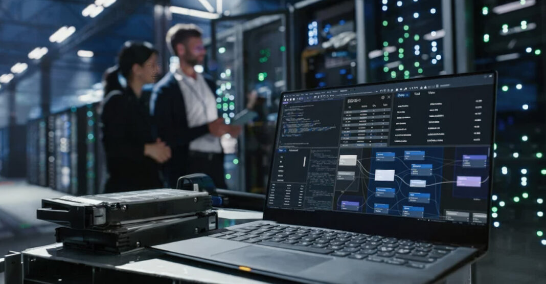 IT infrastructure monitoring in server room illustrates technical maintenance preventing website ranking issues Laptop displaying network diagnostics software positioned in data center with illuminated server racks, representing technical infrastructure maintenance that prevents website performance issues.