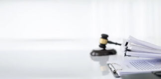 London SEO: Why Law Business Directories Matter Wooden gavel and stacked legal documents with binder clips on white desk, representing the professional foundation of law firm directory presence.