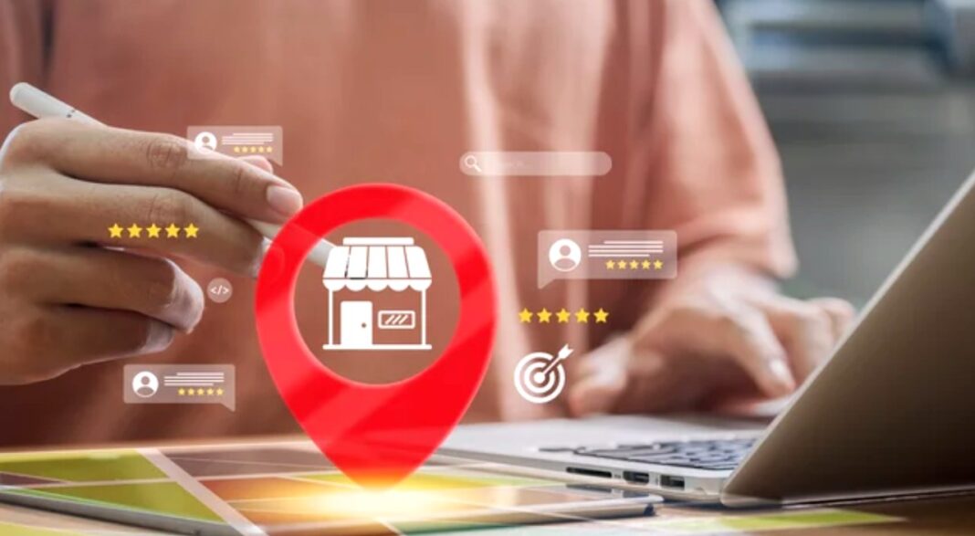 Digital tools connect consumers to local businesses through search and reviews Hands typing on laptop and holding smartphone with digital overlay showing location pin, storefront icon, and star ratings, illustrating local business search directories.