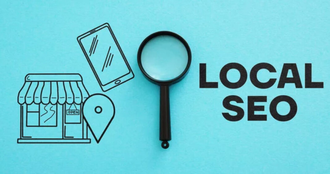 local-seo-concept-flat-lay-magnifying-glass-storefront-illustration Flat-lay composition with black magnifying glass and illustrated storefront, smartphone, and location pin on turquoise background, representing local search engine optimization concepts for neighborhood businesses.