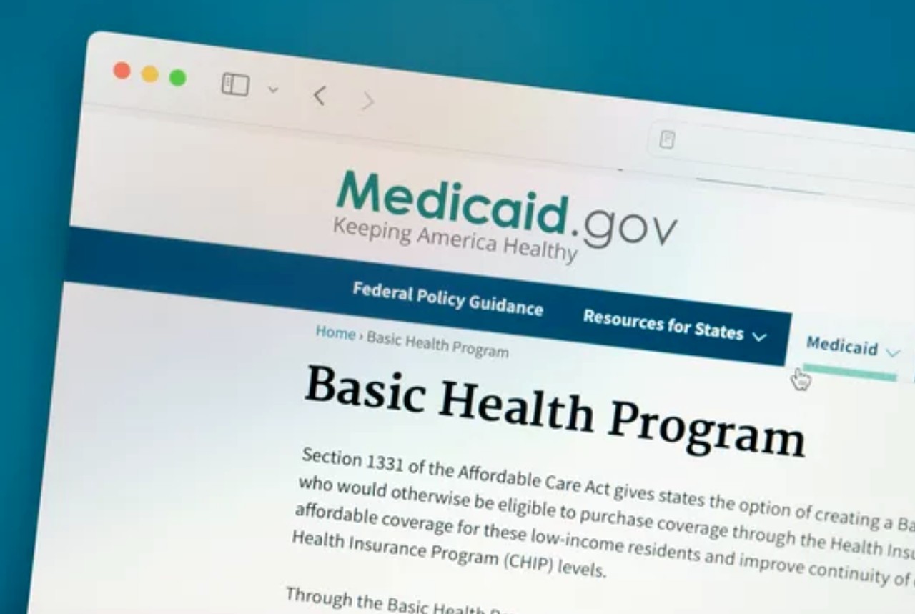 Web browser displaying Medicaid.gov homepage with Basic Health Program section, illustrating government resources available for reducing prescription medication costs.