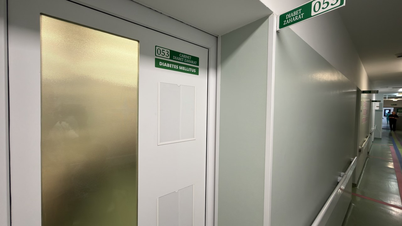 Clean hospital corridor with frosted glass door marked for diabetes mellitus office, representing the clinical settings featured in healthcare provider directory listings.