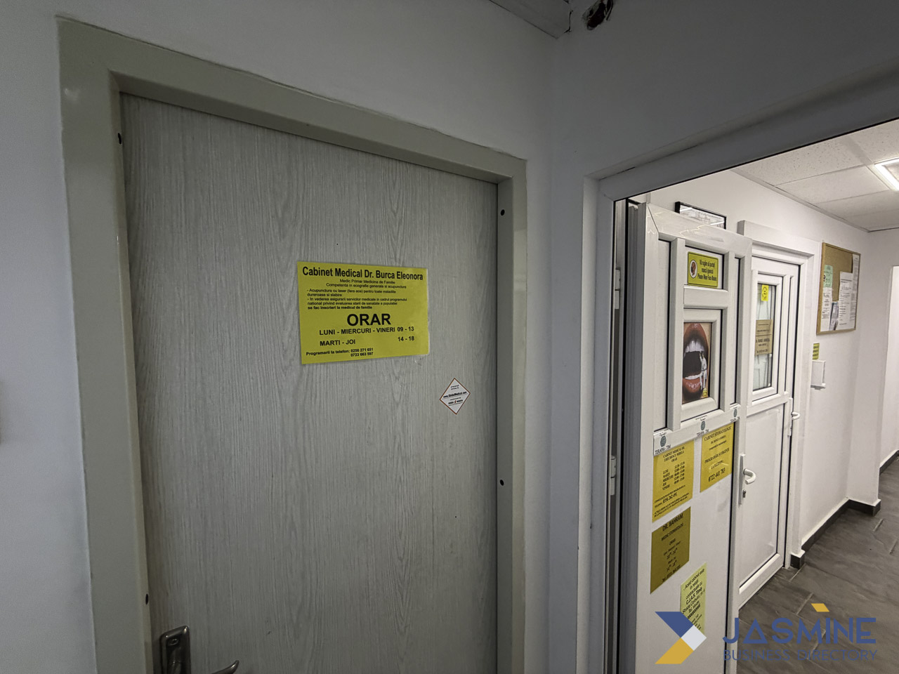 Medical office hallway with wooden door and yellow schedule sign, illustrating healthcare provider accessibility and appointment scheduling for directory listings.