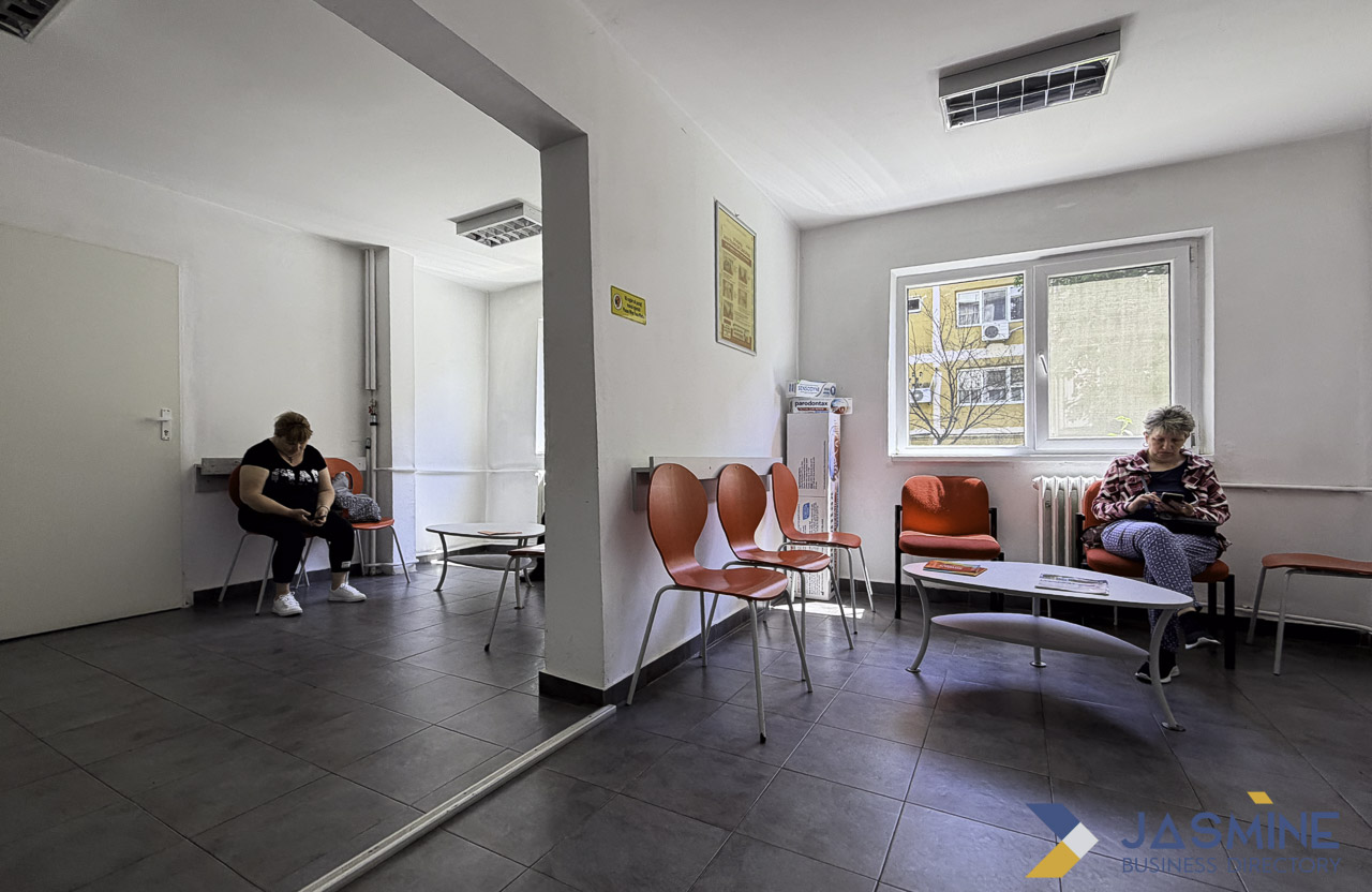 A contemporary medical waiting room with orange chairs and two seated patients, representing the healthcare access experience central to provider directory platforms.