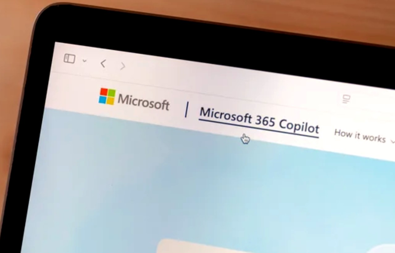 Tablet screen showing Microsoft 365 Copilot webpage with colorful logo and navigation elements, representing modern web application interfaces and development platforms.