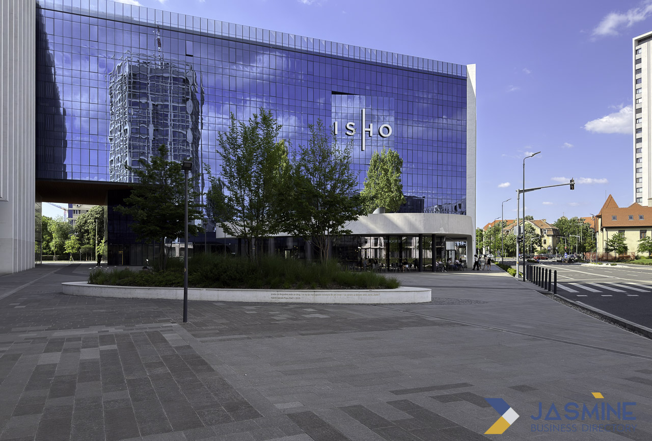 A modern glass-facade office building with blue reflective surfaces in Timișoara, representing the type of commercial establishment that benefits from local marketing strategies.