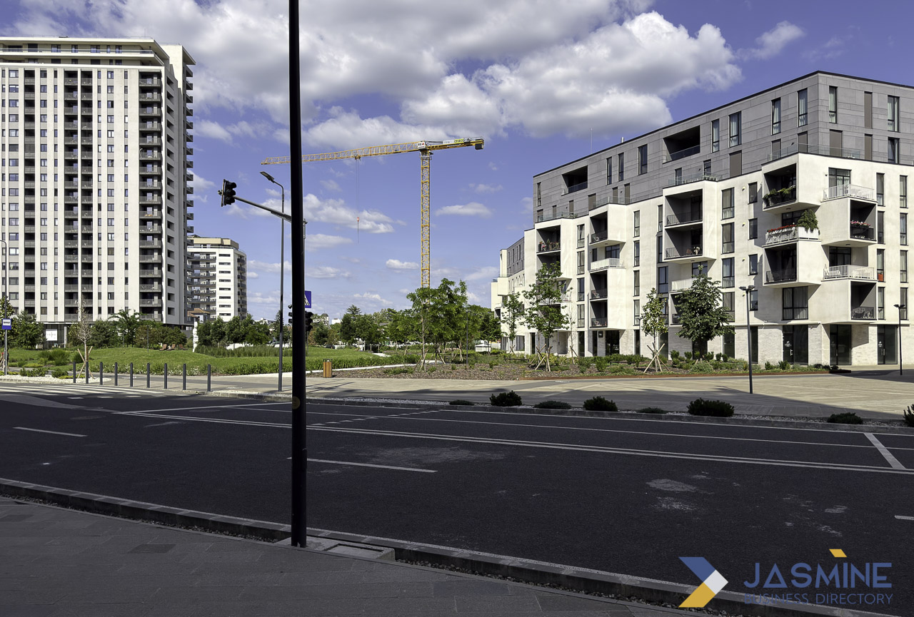 Newly constructed apartment buildings line a paved road in Timișoara, Romania, illustrating hyperlocal neighborhood documentation for real estate SEO strategies.