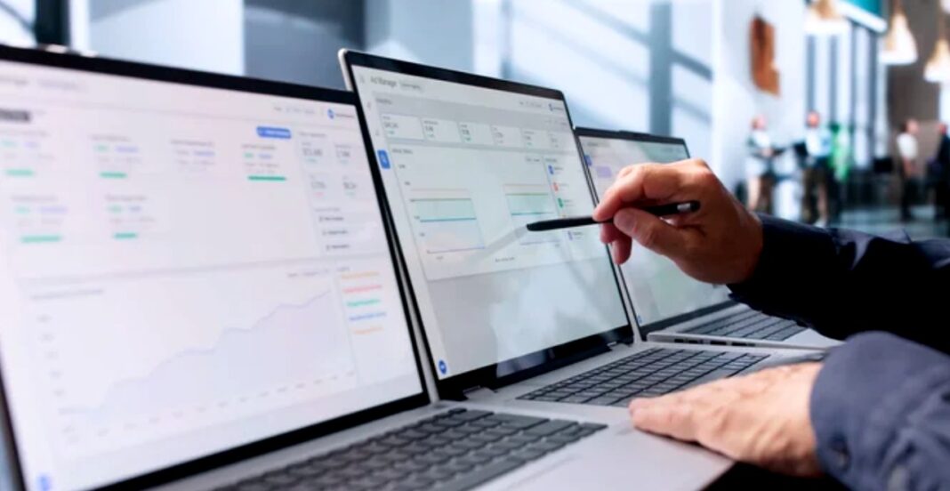 Coordinating multiple directory platforms simultaneously on separate devices for streamlined business management Three laptops on an office desk display business scheduling software while a hand with pen points at the center screen, illustrating multi-platform directory coordination.