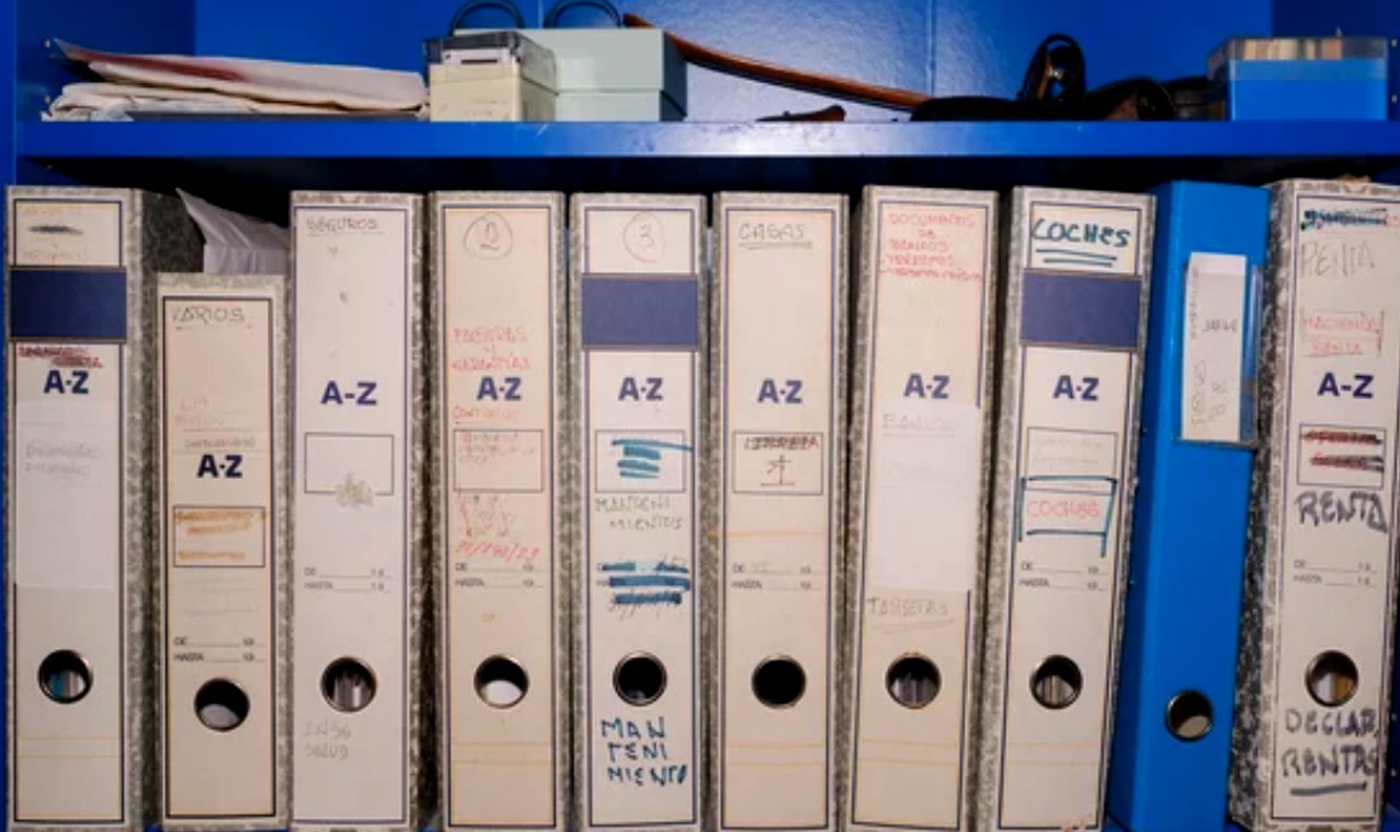 White A-Z labeled file binders arranged on a metal shelf, representing the systematic organization required for maintaining comprehensive business directory lists.