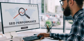 How a Fast Site Makes You More Money Office worker in plaid shirt views computer monitor showing SEO performance dashboard with upward trend arrow, representing the connection between website optimization and revenue generation.