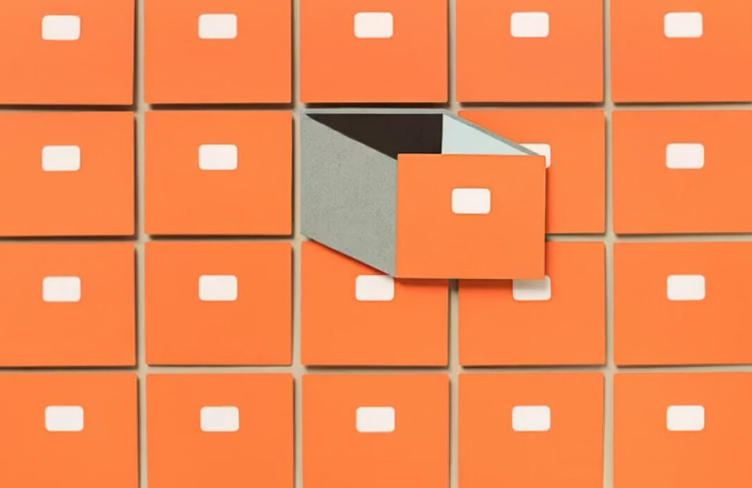 Organized filing drawer system illustrating the power of specialized categorization and niche focus Orange filing cabinet drawers arranged in a grid with one drawer open showing compartments, symbolizing the organized categorization central to niche directory success.