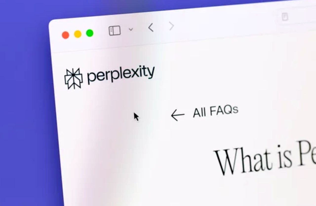 Browser window showing Perplexity website homepage with geometric logo and FAQ navigation, illustrating one of the AI search platforms compared in the article.