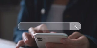 Person holds white smartphone with transparent search bar overlay and magnifying glass icon, representing the evolution toward intent-based targeting in modern search behavior.