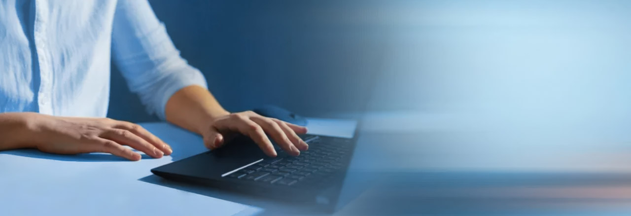 Close-up of hands typing on a laptop keyboard at a professional workspace, representing user interaction with English-friendly Asian business directory platforms.