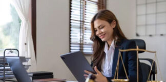 The Most Trusted Directories on the Web Professional woman in business suit reviewing documents at desk with scales of justice and gavel, representing thorough verification and credibility in trusted directories.